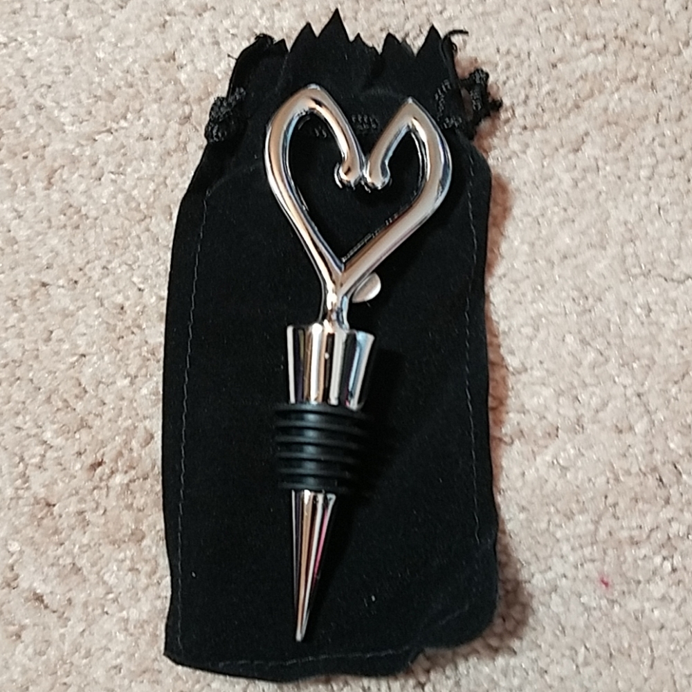 Silver heart-shaped wine bottle stopper and bag